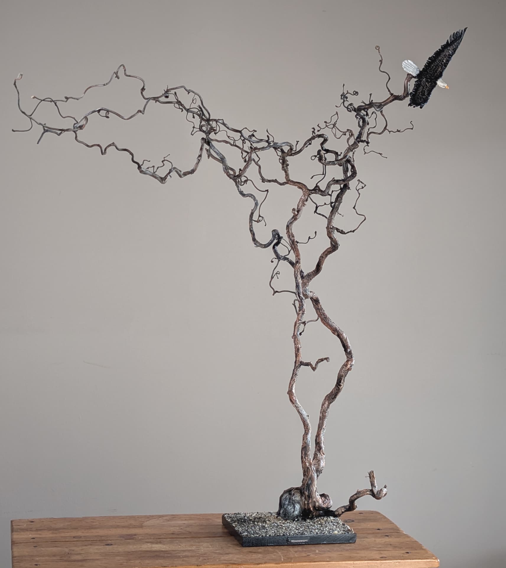 Windswept — mixed media eagle sculpture on reclaimed wood, 44″ tall