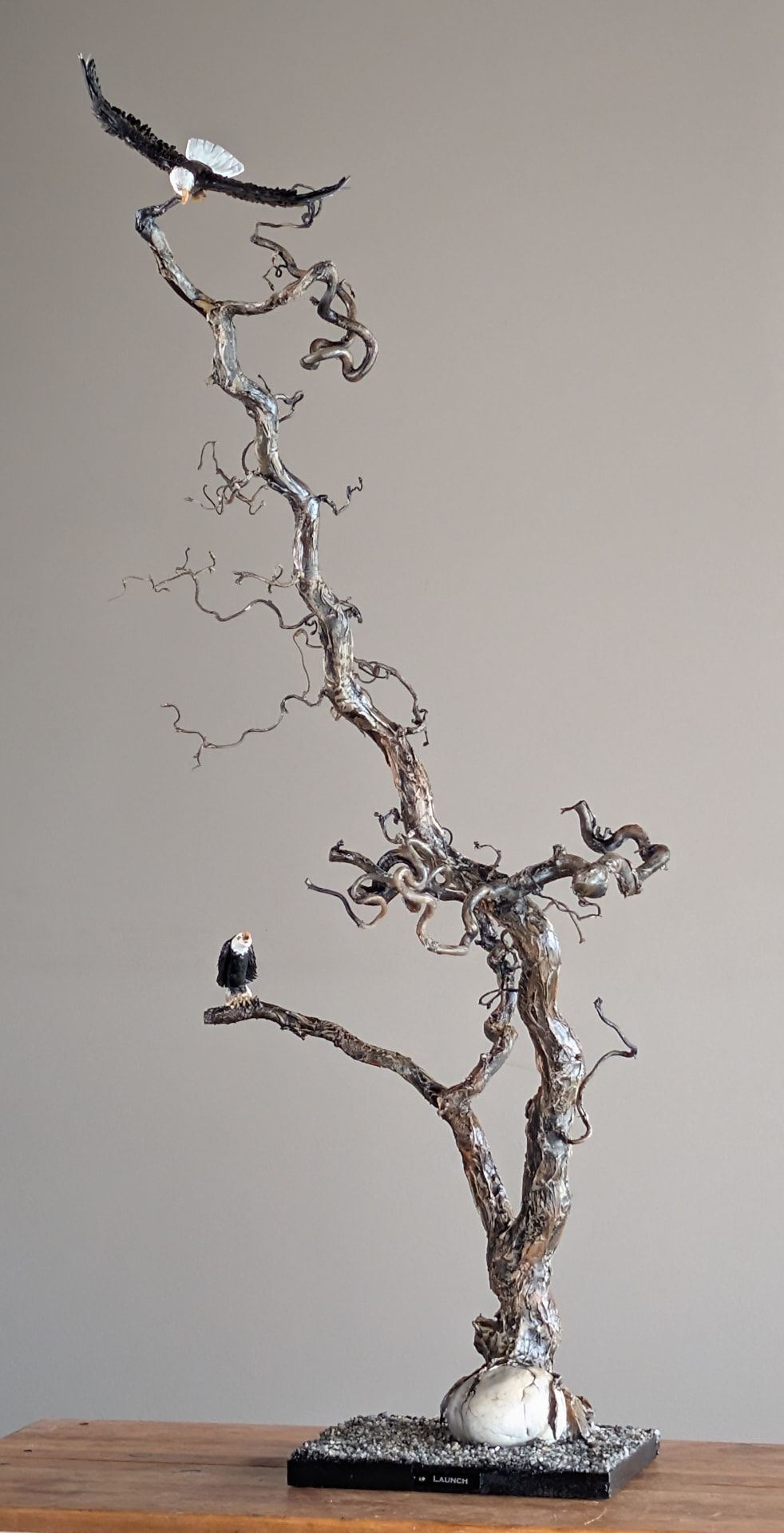 Launch — mixed media eagle sculpture on reclaimed wood, 42¾″ tall
